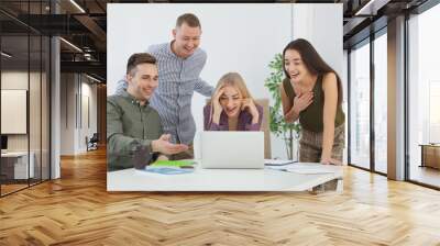 Group of colleagues laughing together in office Wall mural