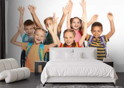 Group of little school children with backpacks on white background Wall mural