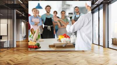 Group of people and female chef at cooking classes Wall mural