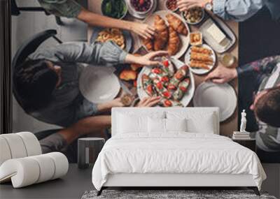 Group of people having brunch together at table indoors, top view Wall mural