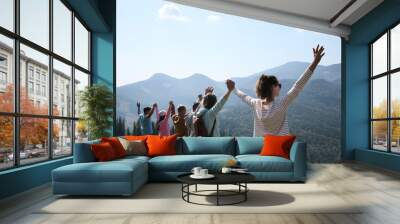 Group of people spending time together in mountains Wall mural