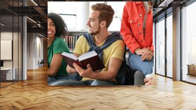 Group of young students at table in library. Banner design Wall mural