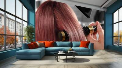 Hairdresser blow drying client's pink hair in salon, closeup Wall mural