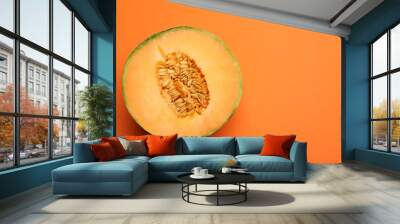 Half of fresh Cantaloupe melon on orange table, top view. Space for text Wall mural