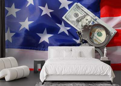 Handcuffs with dollar banknotes on American flag, flat lay. Space for text Wall mural