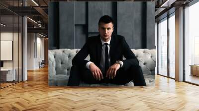 Handsome businessman on sofa indoors. Luxury lifestyle Wall mural