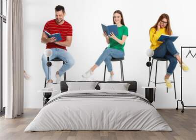 Handsome man reading book on white background Wall mural