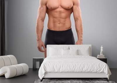 Handsome muscular man on light grey background. Sexy body Wall mural