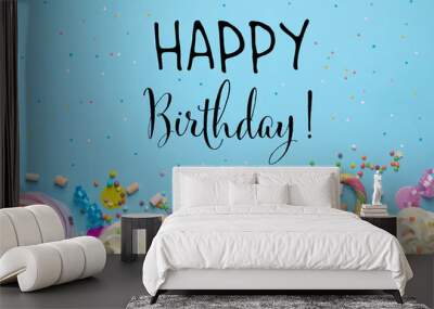 Happy Birthday! Flat lay composition with cupcakes on light blue background Wall mural