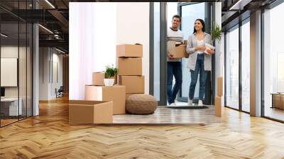 Happy couple entering their new flat with moving boxes Wall mural