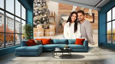 Happy couple in living room decorated for Christmas Wall mural