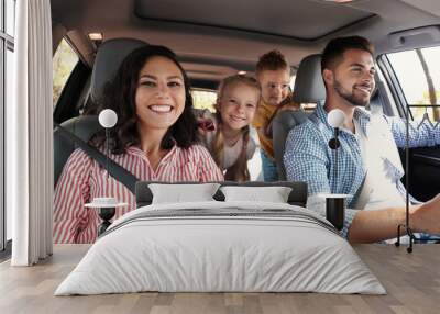 Happy family in car on road trip Wall mural