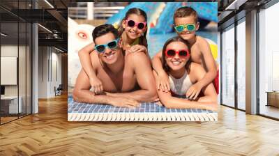 Happy family in swimming pool. Summer vacation Wall mural