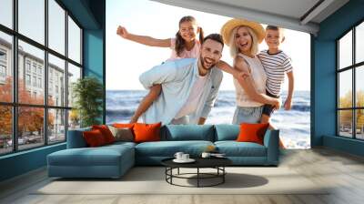 Happy family on beach near sea. Summer vacation Wall mural