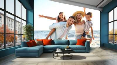 Happy family on beach near sea. Summer vacation Wall mural