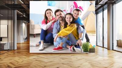 Happy family spending time together during Easter holiday at home Wall mural