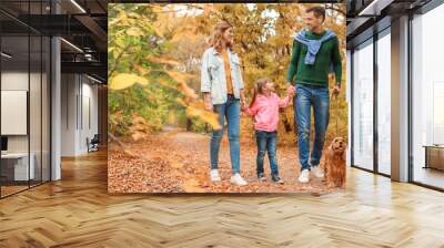 Happy family with child and dog in park. Autumn walk Wall mural