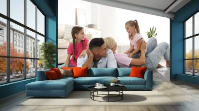 Happy family with children on floor at home Wall mural