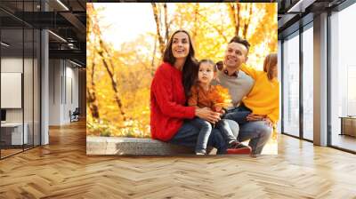 Happy family with little daughters in park. Autumn walk Wall mural