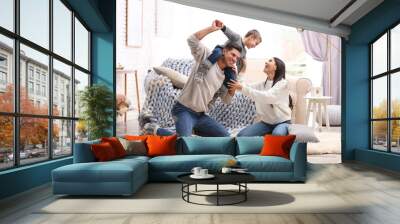 Happy family with little son having fun at home. Winter vacation Wall mural