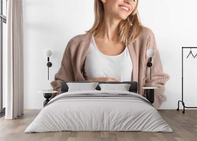 Happy pregnant woman touching her belly on white background Wall mural