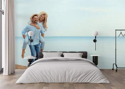 Happy romantic couple walking on beach, space for text Wall mural