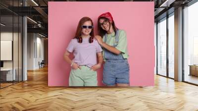 Happy teenage girls posing on pink background Wall mural