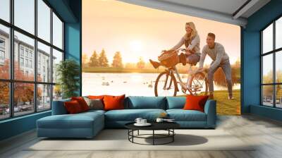 Happy young couple with bicycle having fun outdoors. Time for picnic Wall mural