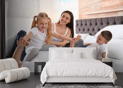 Happy young family together on large bed Wall mural