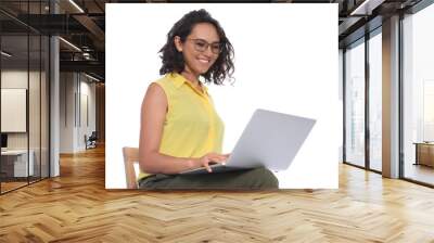 Happy young woman sitting on chair and working with laptop on white background Wall mural