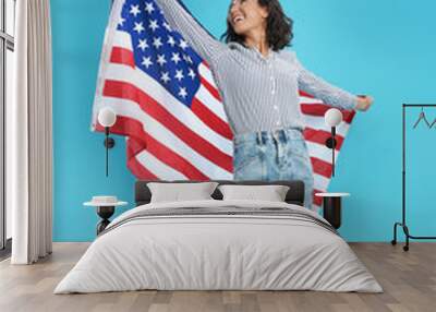 happy young woman with USA flag on blue background Wall mural