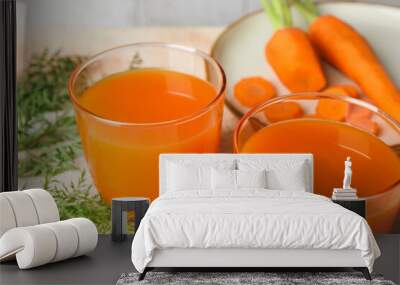 Healthy carrot juice in glasses and fresh vegetables on color textured table, closeup Wall mural