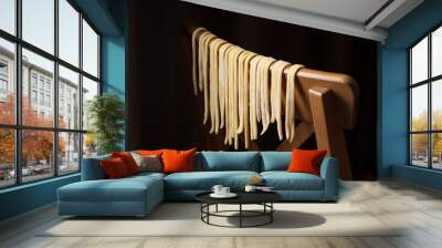 Homemade pasta drying on chair against dark background, closeup Wall mural