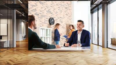 Human resources manager conducting job interview with applicant in office Wall mural