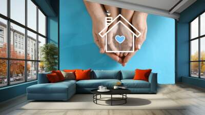 Illustration of house and happy family holding hands on blue background, top view Wall mural