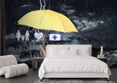 Insurance agent covering illustrations with yellow umbrella during storm Wall mural