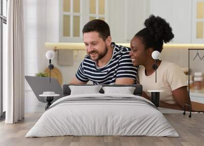 International relationships. Lovely couple spending time together in kitchen Wall mural