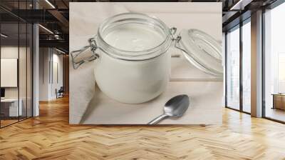 Jar of tasty organic yogurt on white wooden table Wall mural