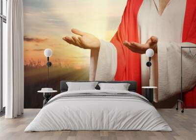 Jesus Christ reaching out his hands and praying at sunset Wall mural