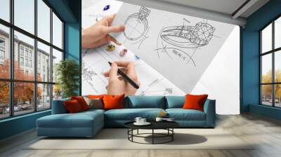 Jeweler with sketches of elegant jewelry at white wooden table, closeup Wall mural