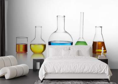 Laboratory glassware with color liquids on white background Wall mural