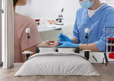 Laboratory testing. Doctor taking blood sample from patient at white table in hospital, closeup Wall mural