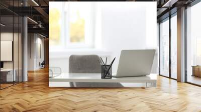 Laptop and stationery on white table in office. Modern workplace Wall mural