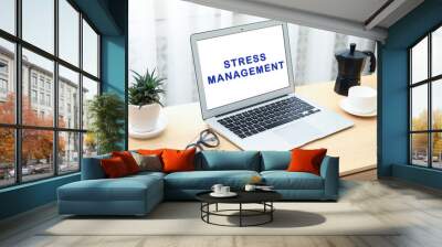 Laptop with text Stress Management on screen at workplace Wall mural