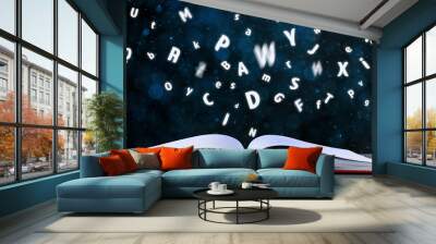 Letters flying out of open book on table, bokeh effect. Banner design Wall mural