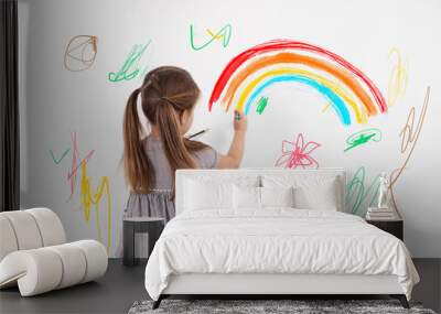 Little child drawing on white wall, back view Wall mural