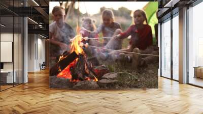 Little children frying marshmallows on bonfire. Summer camp Wall mural