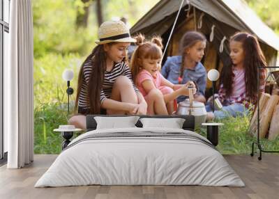 Little children near tent outdoors. Summer camp Wall mural