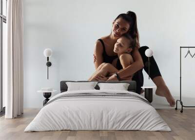 Little gymnast and her coach sitting on white background Wall mural