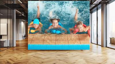 Little kids with swimming noodles in indoor pool Wall mural